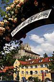 Old town and castle through rose covered arch, Meersburg, Baden Wurttemberg, Germany