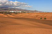 View over sand dunes to distant town, Maspalomas, Gran Canaria, Canary Islands