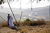 Women hanging clothes on the washing line, Odeceixe, Algarve, Portugal