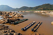 Blick über den Mekong mit Klippen und Fischerbooten nach Laos, Pak Chom, Provinz Loei, Thailand, Asien