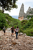 Three hikers on a stony hiking trail, Punta Goloritzé, Golfo di Orosei, Sardinia, Italy, Europe