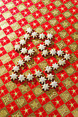 Christmas cookies cinnamon stars laying in shape of tree on wrapping paper