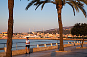 Jogger at waterfront promenade Avinguda Gabriel Roca in the morning sun, Palma, Mallorca, Balearic Islands, Mediterranean Sea, Spain, Europe