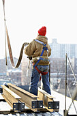 Construction steel iron worker from the back with harness on