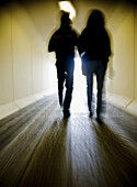 persons walking in a tunnel