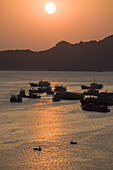 Sunset over the harbour of Cat-Ba Town, Halong Bay at the Gulf of Tonkin, Vietnam, Asia
