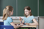 Two schoolgirls in classroom, Hamburg, Germany