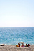 People sunbathing on the city beach of Nice, Nice, Cote d'Azur, France, Europe