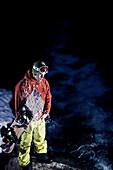 Snowboarder standing near torrent, Kappl, Tyrol, Austria
