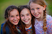 Three girls smiling at camera, Munsing, Bavaria, Germany