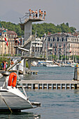 Bathing And Relaxing At The Diving Board Of The Bains Des Paquis In The Geneva Harbour On Lake Geneva, Switzerland