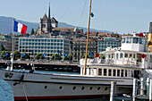 Cruise Boat On Lake Geneva In Front Of The City Of Geneva And Saint Peter'S Cathedral, Geneva, Switzerland