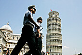Police Officer (Carabinieri) By The Leaning Tower (Torre Pendente), Baptistery And Cathedral (Duomo) On The Campo Dei Miracoli, Pisa, Tuscany, Italy