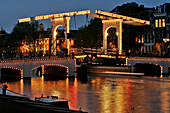 The Skinny Bridge, 'Magere Brug', The Most Famous Of The 1280 Bridges In Amsterdam. A Traditional Wood, Double-Swipe Bridge Linking The Two Sides Of The Amstel, Amsterdam, Netherlands