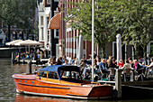 Boat And Sidewalk Cafe On The Kloveniersburgwal Canal, Amsterdam, Netherlands