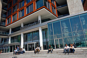 Students Sitting On The Steps Of The Openbare Bibliotheek Amsterdam, The Oba Covers Thirteen Storeys, The Big Library Of Amsterdam Counts 28, 000 Square Meters Of Books, Magazines, Newspapers And Dvds, Two Restaurants And Two Theaters