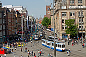 Tramways On Damrak Street, Beurs Van Berlage And Main Train Station At The Bottom Of Dam Platz, Amsterdam, Netherlands, Holland