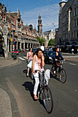 Woman On A Bike While Talking On The Telephone, Amsterdam, Netherlands, Holland