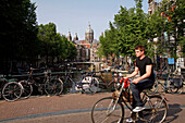 Dutch Bikes On A Canal'S Bridge And Sint Nicolaaskerk Church
