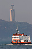 Ferry On The Tagus Across From The Statue Of 'Cristo Rei', Lisbon
