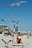 Mother And Her Daughter Feeding Seagulls, Miami Beach, South Beach, Miami, Florida, United States, Usa
