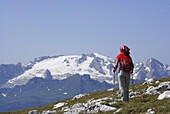 Woman hiking, Marmolada in background, Naturpark Fanes-Sennes-Prags, Dolomites, Trentino-Alto Adige/South Tyrol, Italy