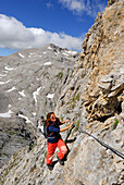 Woman climbing at Via Ferrata Omretta, Cima Ombretta, Marmolada, Dolomites, Trentino-Alto Adige/South Tyrol, Italy