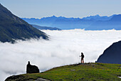 Woman looking over sea of fog, Lower Engadin, Engadin, Canton of Grisons, Switzerland