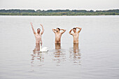 Three naked men inside Cospuden Lake, Leipzig, Saxony, Germany