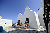 People in front of the Panagia Paraportiani church, island of Mykonos, the Cyclades, Greece, Europe