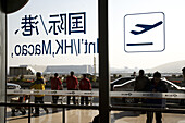 Blick durch Glastür auf Menschen vor dem Internationalen Flughafen Peking, größtes Gebäude der Welt, Beijing, Peking, China, Asien
