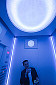 Man at fast elevator to observation floor of the World Trade Financial Center, Shanghai, China, Asia