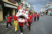 Teenagers at dragon dance during Tet festival at a suburb, Saigon, Ho Chi Minh City, Vietnam, Asia