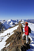 Woman enjoying view from Monte Vioz, Ortler range, Trentino-Alto Adige/South Tyrol, Italy
