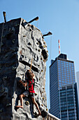 Child on a climbing wall, Opera Square, Frankfurt am Main, Hesse, Germany