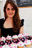 Young woman selling cup cakes, muffins, Saturday market at the Old Biscuit Mill in the Woodstock district of Capetown, Western Cape, RSA, South Africa, Africa
