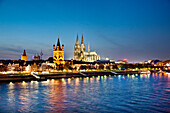View ove river Rhine to old town with cathedral and Great St. Martin church, Cologne, North Rhine-Westphalia, Germany