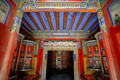 the entrance to one of the many prayer rooms and Prayer Wheels at labrang gompa in China, Sichuan province