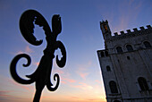 Gubbio Umbria Italy Palazzo dei Consoli and the wrought iron Fleur de Lys,  a motif found throughout the town