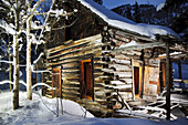 An abandoned old cabin glowing with light Colorado,  United States
