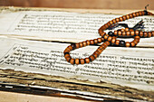 Tibetan prayer beads and ancient holy text Chemre,  Ladakh,  India