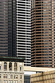 Juxiposition of high rise buildings against lower,  older ones in downtown Seattle at the edge of the historic district