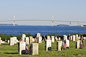 Historic cemetery at Fort Adams State Park in Newport Rhode Island with Narragansett Bay and pell Bridge beyond