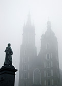 Poland Krakow Church of St Mary at Main Market Square at foggy day