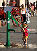 Poland,  Krakow,  Girl by well at Main Market Square