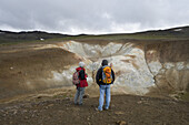 Two hikers at Krafla Geothermal Area, Krafla, Nordurland Eystra, Iceland, Europe