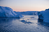 View at icebergs from Ilulissat Kangerlua Icefjord at dusk, Ilulissat (Jakobshavn), Disko Bay, Kitaa, Greenland