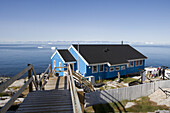 Wooden house and view at icebergs of Ilulissat Kangerlua Isfjord, Ilulissat (Jakobshavn), Disko Bay, Kitaa, Greenland