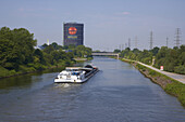 Oberhausen Gasometer with river Rhine-Herne-Canal and lighter, Oberhausen - Neue Mitte, Ruhrgebiet, North Rhine-Westphalia, Germany, Europe