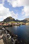 Rorbu huts on the waterfront under clouded sky, Lofoten, Norway, Scandinavia, Europe